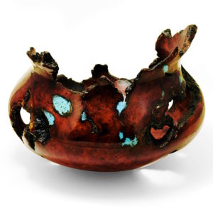 A dark red-brown burl wood turning with turquoise inlay