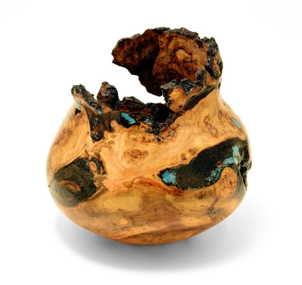 a decorative burl wood turning with inlay and interesting gaps in the form