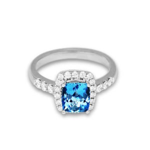 Ring with an aquamarine stone in a cluster of diamondss