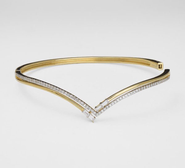 A thin gold bracelet with square and baguette diamonds