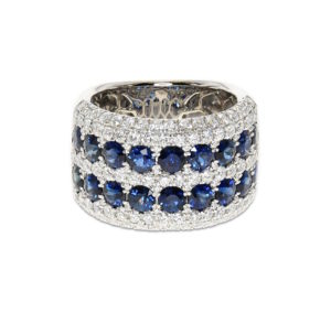 A wide band of white gold with rows of sapphires and diamonds