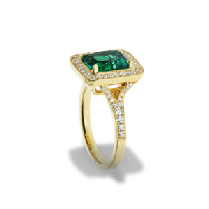 A yellow gold ring with a lrage emerald and diamonds
