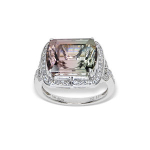 a white gold ring with a large tourmoline gemstone and diamonds